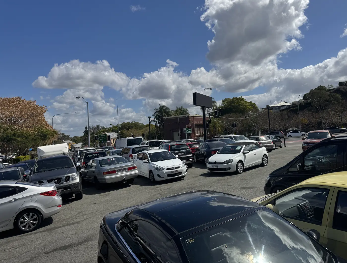 The BrizCars yard in Windsor, Brisbane: rows of used cars under a blue sky