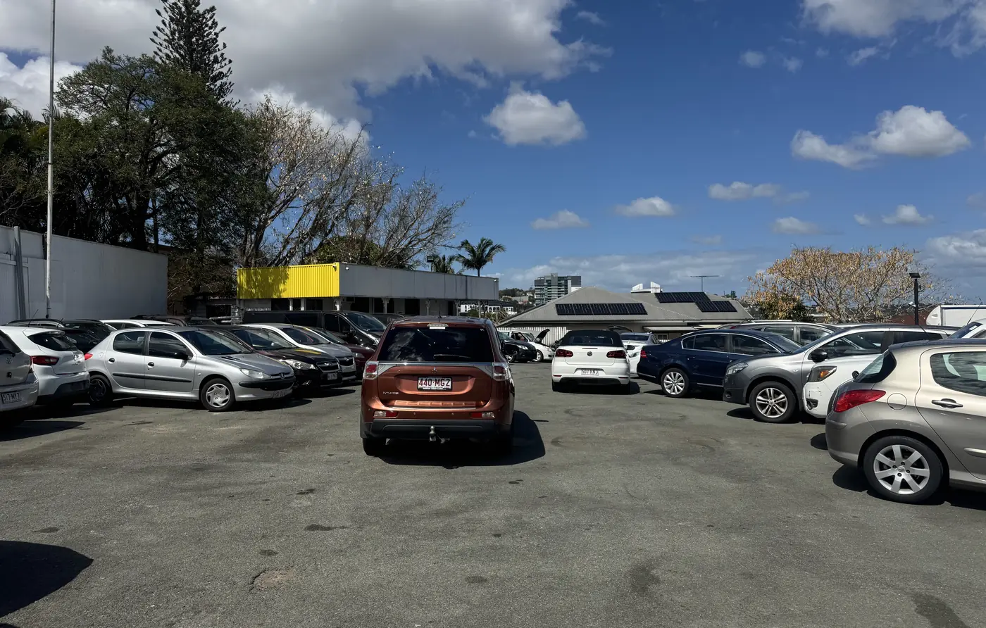 Looking across the BrizCars lot: hatches, sedans and SUVs parked in rows