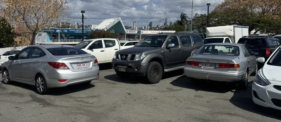 A row of used sedans and a 4WD on the lot